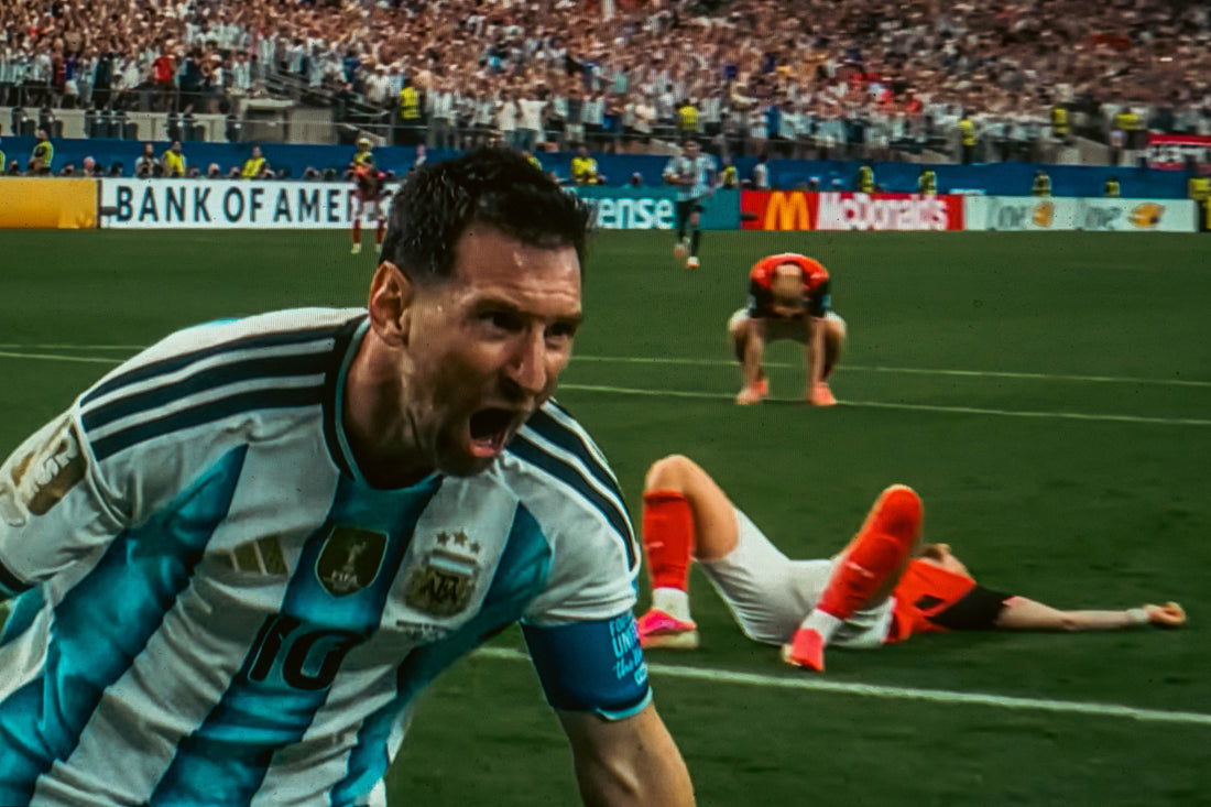 A 2026 FIFA World Cup broadcast photographed from a screen, its reflections and scan lines part of the image.
