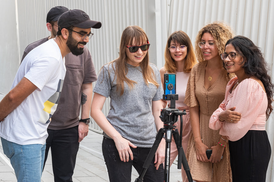 GPP smartphone photography workshop students reviewing a shot on a tripod-mounted phone at Alserkal Avenue, Dubai