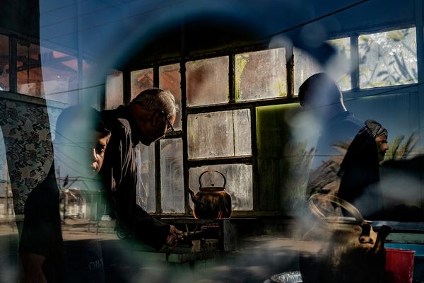Two men are hard at work, making tea In Iraq
