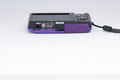 Nikon Coolpix S2600 purple digital camera — bottom view with baseplate (unit 1)