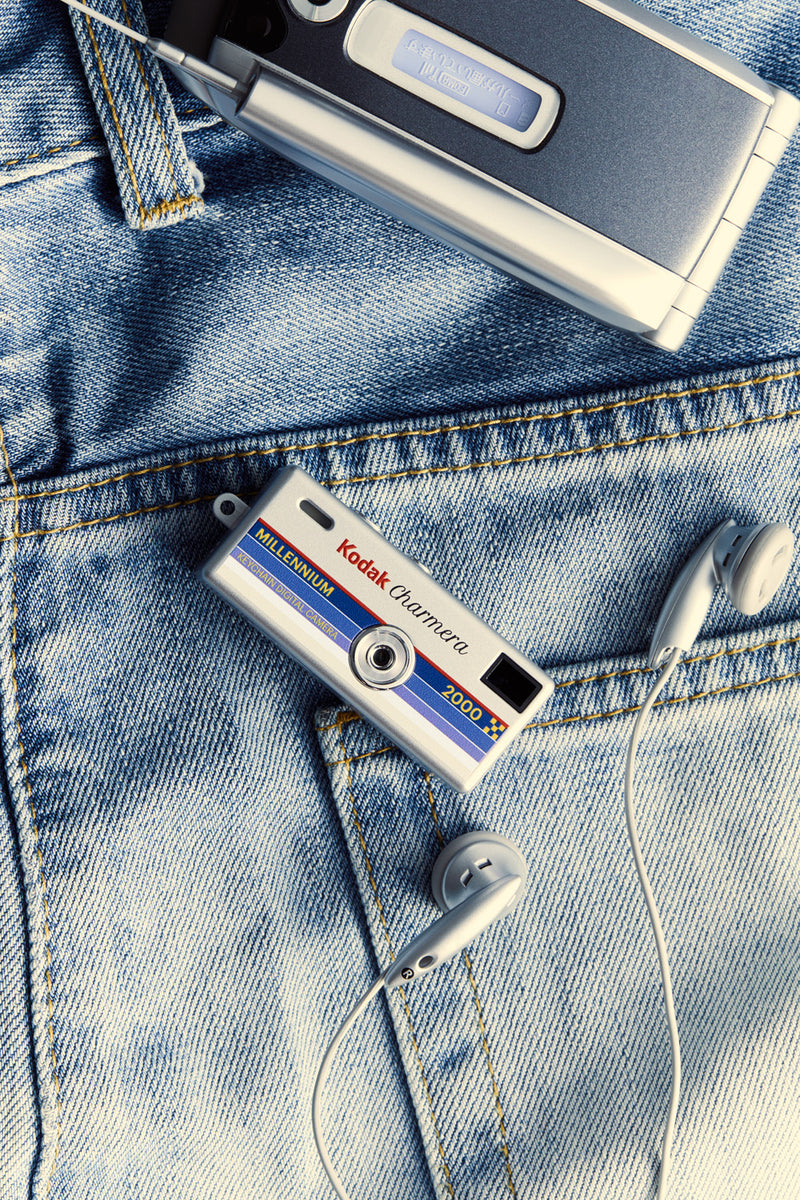 Kodak Charmera Millennium — indoor lifestyle, collector hand with full set