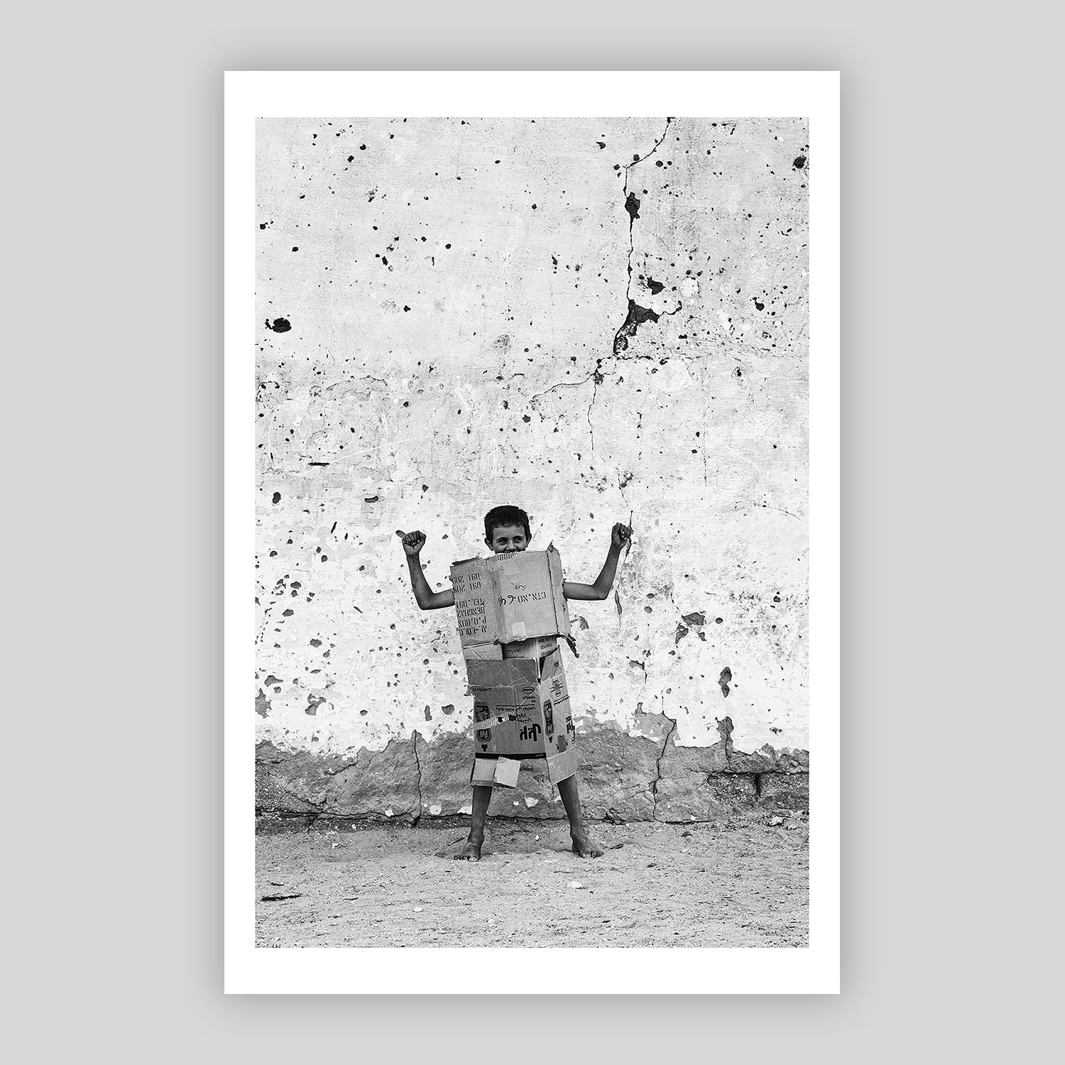 A boy, playing with cardboard armor.